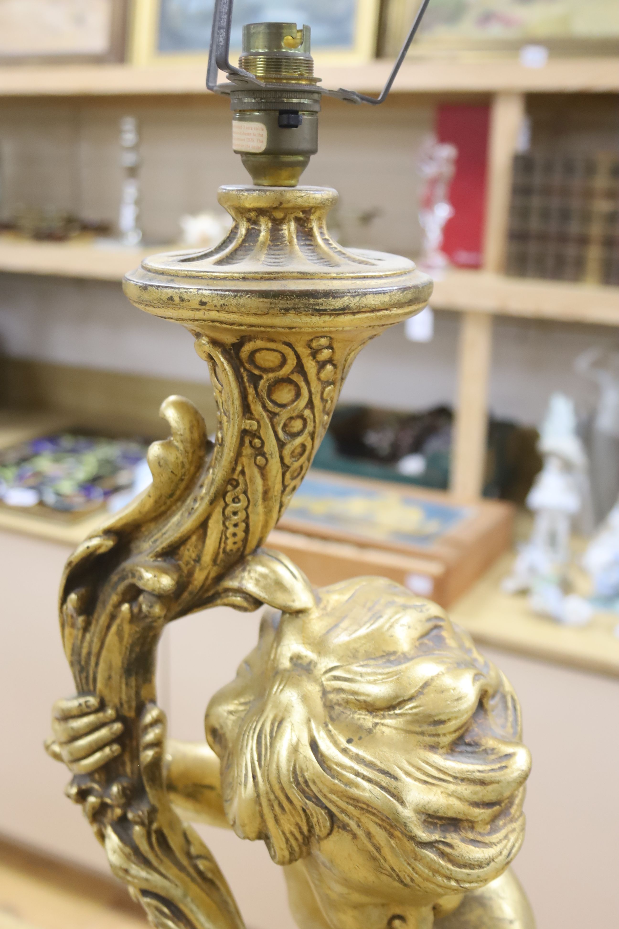 A large moulded gilt putti table lamp, height 70cm excl. light fitting